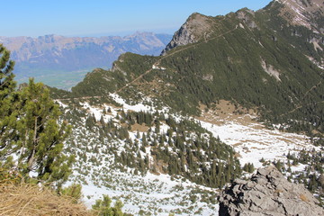 Landscape of snowy Alp mountains with forests, taken from Alpspitz peak in Gaflei village in the municipality of Triesenberg in Principality of Liechtenstein.