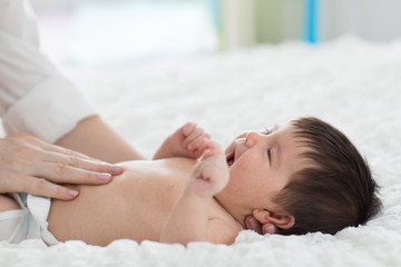 Fototapeta na wymiar Masseur massaging the tummy of the baby