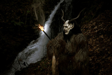 Satan with torch at the waterfall
