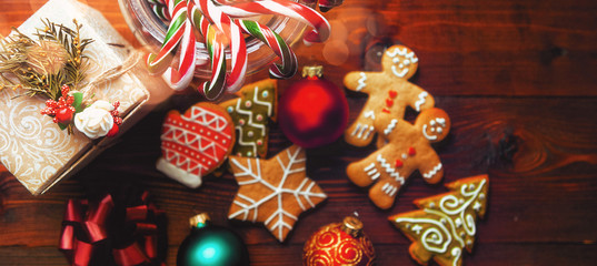 Christmas still life. homemade ginger biscuits, cane candy, on a wooden background.