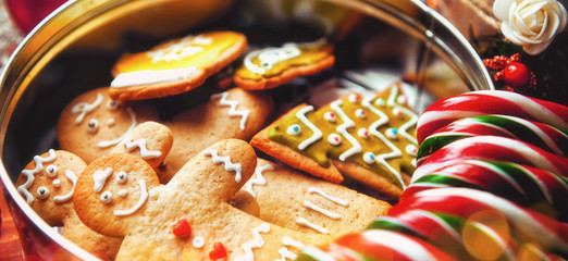 Christmas still life. homemade ginger biscuits, cane candy, on a wooden background.