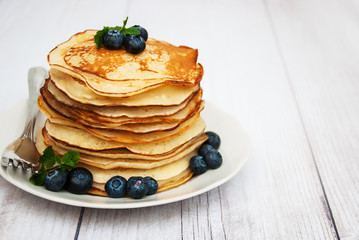 Plate with pancakes and blueberries