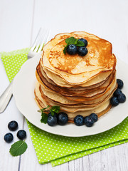 Plate with pancakes and blueberries