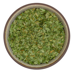 Bio organic dried wild garlic in ceramic bowl isolated on white background, top view in natural light