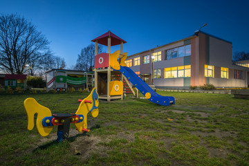 Obraz na płótnie Canvas Brand new playground finished for the kindergarten. Wooden play houses, various attractions for kids to enjoy. 