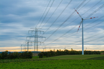 Fototapeta na wymiar Old power source versus new, classic power distribution and wind power, Austria, Europe