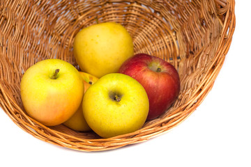 apples in a wicker basket on a white background.