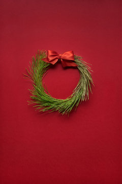 Christmas wreath / Creative concept photo of christmas wreath made of tree on red background.