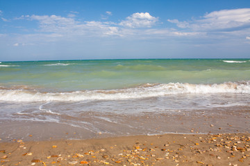 Adriatic Sea coast view. Seashore of Italy, summer sandy beach with clouds on horizon.