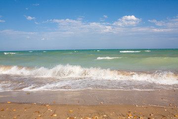 Adriatic Sea coast view. Seashore of Italy, summer sandy beach with clouds on horizon.