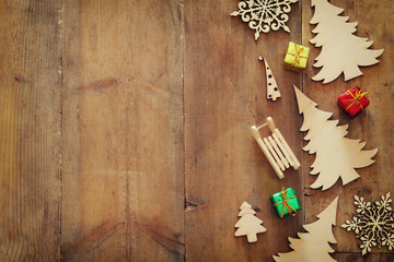 Top view image of christmas festive decorations on wooden background. Flat lay.