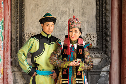 Young Mongolian couple in a traditional 13th century costume in a temple. Ulaanbaatar, Mongolia.