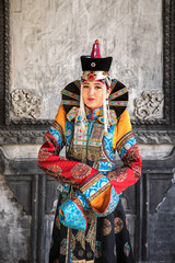 Fototapeta na wymiar Young Mongolian woman in a traditional 13th century costume in a temple. Ulaanbaatar, Mongolia.