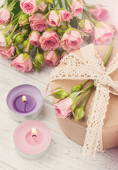 Pink roses with gift box and candle