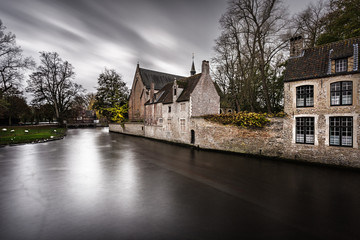 Fototapeta premium Bruges is a beautiful and characteristic town in Flanders (Belgium). The view in a gloomy atmosphere due to the bad weather keeps its charm and character in its historical architecture.
