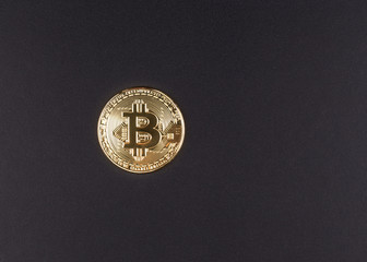Naklejka na ściany i meble Golden bitcoin on black background
