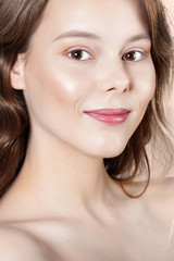 Obraz premium Young smiling girl with clean perfect skin close-up