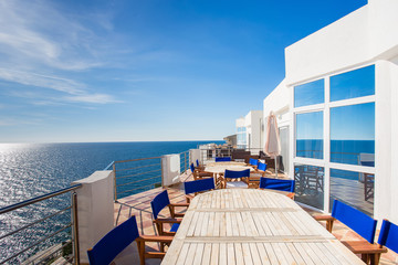 Luxury Sea view terrace with table and chair - obrazy, fototapety, plakaty