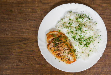 fried chicken breast with rice on a wooden background. with copy space. top view
