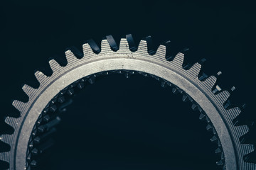Silver toothed shaft on a dark background.