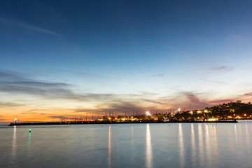 beautiful city lights reflected on water surface at the dusk