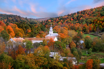 Small church in Topsham village in Vermont in the middle of fall foliage