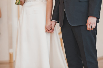 The couple held hands at the marriage ceremony 8904.