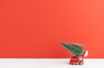 Fototapeta na wymiar toy steam locomotive carries a Christmas tree