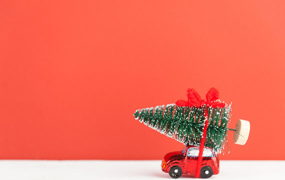 A Toy Car Carries A Christmas Tree