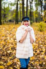 Happy young beauty woman in park on sunny autumn day.