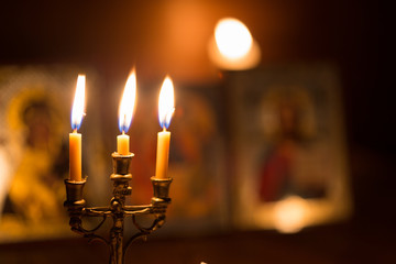 burning candle in a dark room, orthodox