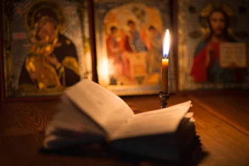 Fotobehang burning candle in a dark room, orthodox © Evgenia Tiplyashina