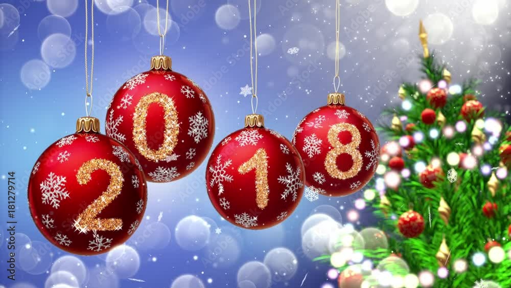 Wall mural red balls with numbers 2018 hanging on the background of a blue bokeh and a rotating christmas tree 