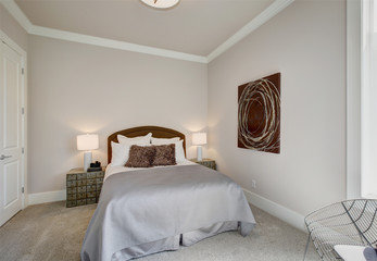 Neat bedroom interior in gray and brown tones
