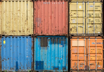 Stack of colourful and rusty containers in the port of Antwerp.