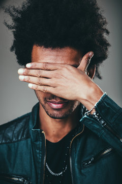 man making facepalm gesture, covering eyes while feeling ashamed