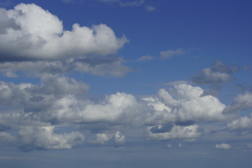 Gorgeous white cumulus clouds on a blue sky. There is space in the upper right corner