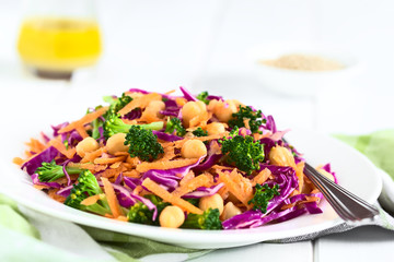 Fresh red cabbage, chickpea, carrot and broccoli salad on plate, photographed with natural light (Selective Focus, Focus in the middle of the image)