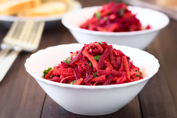 Raw grated beetroot, apple and carrot salad with parsley, photographed with natural light...