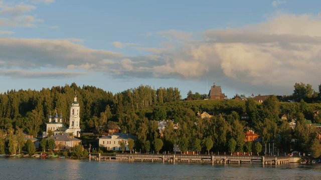 View on russian historical town Plyos on the Volga River from moving cruise ship at sunset
