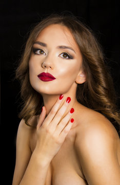 beautiful girl with red lips and nails, glamour evening makeup and hair concept