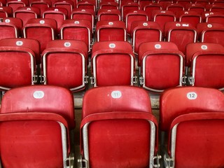 Naklejka premium Empty red plastic seats in a stadium