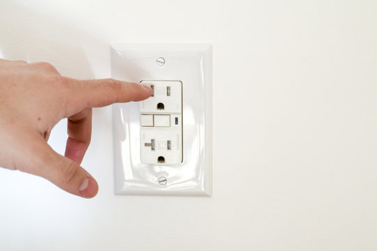 Finger dangerously close to electrical socket