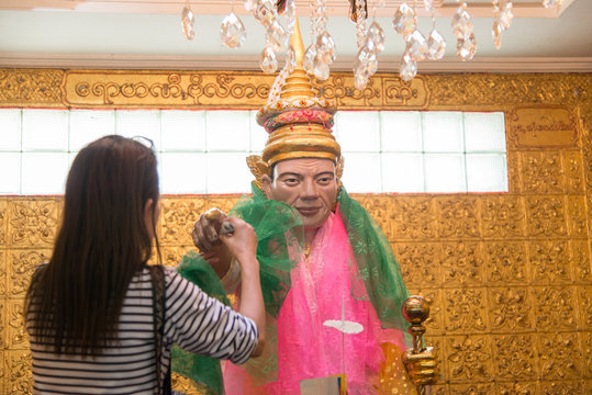 Asian women make a merit with Natbobo Gyi in Botahtaung pagoda of Yangon.