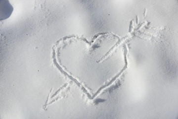 heart pierced by an arrow in the snow drawing a valentine stick
