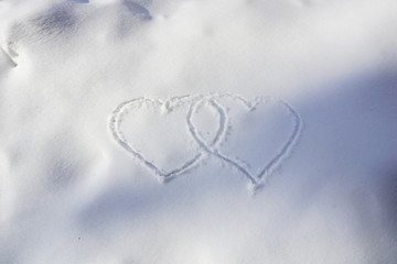 two hearts painted in snow valentine