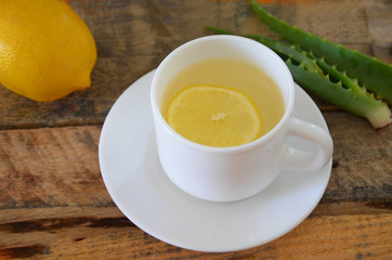 Drink with aloe vera and lemons. Glass cups on wooden background