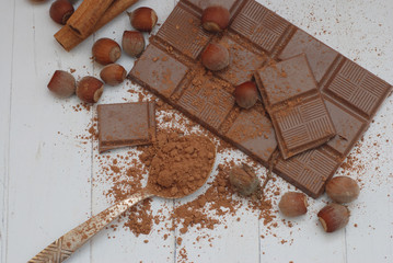 Ingredients for Chocolate Dessert Preparation, Chocolate Bar with cocoa Powder, Nuts, Spoon,...