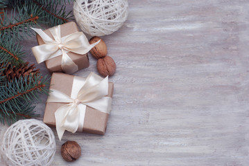 Cristmas Gift Present Brown Box with, Fir Branches, Nuts, on Wooden Background with Copy Space for Text.