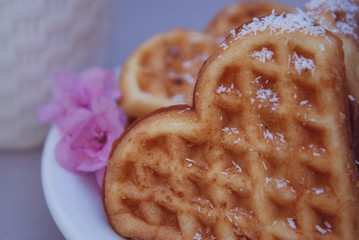 Belgian Waffles Heart with Pink Flowers. Food Dessert Concept. Close Up.